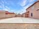 Extended driveway leading to a two-car garage, with block fence and partial desert landscaping at 15819 W Ripple Rd, Goodyear, AZ 85338