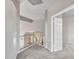 Bright hallway featuring neutral walls and carpet, with staircase views to lower level at 15819 W Ripple Rd, Goodyear, AZ 85338