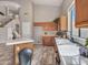 Well-lit kitchen with island, tile countertops and wood cabinets at 15819 W Ripple Rd, Goodyear, AZ 85338