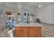 Bright kitchen featuring tiled countertops and island with access to backyard views at 15819 W Ripple Rd, Goodyear, AZ 85338