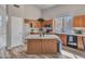 Bright kitchen featuring tiled countertops and island with modern appliances at 15819 W Ripple Rd, Goodyear, AZ 85338