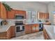 Kitchen with stainless steel appliances, tile countertops, and wood cabinets at 15819 W Ripple Rd, Goodyear, AZ 85338