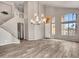 Spacious living room with modern lighting, an adjacent staircase and hardwood-style floors at 15819 W Ripple Rd, Goodyear, AZ 85338