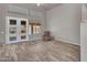 Cozy living room with hardwood-style floors, access to the yard, and neutral paint at 15819 W Ripple Rd, Goodyear, AZ 85338