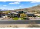 Expansive aerial view of modern home, showing landscaping, desert surroundings and mountain views at 16908 S 31St Ln, Phoenix, AZ 85045