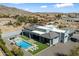 Modern home with a backyard oasis, featuring a sparkling pool, spa, and lush landscaping against a mountain backdrop at 16908 S 31St Ln, Phoenix, AZ 85045