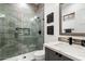 Modern bathroom with gray tile, glass shower, and stylish decor accents at 16908 S 31St Ln, Phoenix, AZ 85045