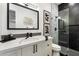 Stylish bathroom featuring black and white tile, a marble countertop, and glass-enclosed shower at 16908 S 31St Ln, Phoenix, AZ 85045