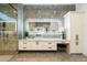 Spa-like bathroom with grey marble walls, a make up vanity, and glass shower enclosure at 16908 S 31St Ln, Phoenix, AZ 85045