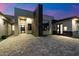 Striking modern home exterior featuring a stone accent wall and sleek, contemporary design elements at 16908 S 31St Ln, Phoenix, AZ 85045