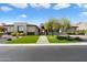 Landscaped front yard with desert plants, manicured turf, and a modern facade on a bright day at 16908 S 31St Ln, Phoenix, AZ 85045