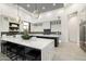 Stylish kitchen with a center island, black backsplash, and modern pendant lighting at 16908 S 31St Ln, Phoenix, AZ 85045