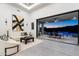 Open living area with tile flooring, stylish seating, and a seamless transition to an outdoor living space at 16908 S 31St Ln, Phoenix, AZ 85045