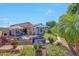 Expansive backyard featuring a patio, outdoor seating, lush landscaping, and a well-manicured lawn at 17210 N Firestone Ln, Surprise, AZ 85374