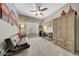 Bedroom with a ceiling fan, sofa, desk, and closet at 17210 N Firestone Ln, Surprise, AZ 85374