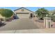 Single Gathering home with desert landscaping, a two car garage, and tile roof at 17210 N Firestone Ln, Surprise, AZ 85374