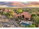 Aerial view of the private backyard oasis featuring pool, spa, outdoor kitchen, and desert landscape at 18683 N 101St Pl, Scottsdale, AZ 85255