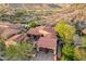 Aerial view of the home highlighting the three car garage, landscaped front yard, and tile roof at 18683 N 101St Pl, Scottsdale, AZ 85255