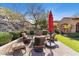 Inviting backyard featuring a seating area, lush landscaping, and charming architecture at 18683 N 101St Pl, Scottsdale, AZ 85255