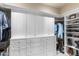 Well-organized walk-in closet with custom built-in shelving and storage at 18683 N 101St Pl, Scottsdale, AZ 85255