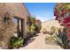 Beautiful courtyard with brick pavers, desert landscaping, and outdoor seating area under a clear, sunny sky at 18683 N 101St Pl, Scottsdale, AZ 85255