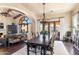 Formal dining room with dark wood table, upholstered chairs, and elegant chandelier at 18683 N 101St Pl, Scottsdale, AZ 85255