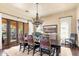 Elegant dining room featuring a large wood table, decorative chairs, and views of the outdoors at 18683 N 101St Pl, Scottsdale, AZ 85255