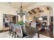 Elegant dining room featuring a dark wood table, patterned chairs, and a decorative chandelier at 18683 N 101St Pl, Scottsdale, AZ 85255