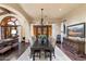 Elegant dining room featuring a large table, chandelier lighting, and access to an outdoor patio at 18683 N 101St Pl, Scottsdale, AZ 85255