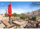 Relaxing backyard with a stone fire pit, seating, and landscaped surroundings at 18683 N 101St Pl, Scottsdale, AZ 85255