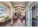 Grand entryway with beamed ceilings, arched doorways, and a view into the spacious living room at 18683 N 101St Pl, Scottsdale, AZ 85255