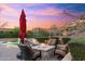 Backyard view of a patio with firepit and a swimming pool with mountain view in the background at 18683 N 101St Pl, Scottsdale, AZ 85255