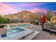 Swimming pool with spa in the background featuring mountain views and outdoor seating area at 18683 N 101St Pl, Scottsdale, AZ 85255