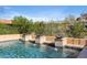 Inviting pool featuring water fountains and a serene desert backdrop, perfect for relaxation at 18683 N 101St Pl, Scottsdale, AZ 85255