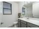 Well-lit bathroom featuring a single sink vanity, a large mirror, and a shower providing a clean and modern space at 18811 W San Miguel Ave, Litchfield Park, AZ 85340