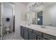 Elegant bathroom featuring double sinks, a large mirror, and a separate toilet area providing comfort and privacy at 18811 W San Miguel Ave, Litchfield Park, AZ 85340