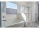 Bright bathroom with soaking tub, large window and glass enclosed shower at 18811 W San Miguel Ave, Litchfield Park, AZ 85340