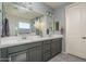 This light bathroom features double sinks, a large mirror, and white countertops at 18811 W San Miguel Ave, Litchfield Park, AZ 85340