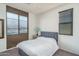 Inviting bedroom featuring a comfortable bed, a nightstand, and a large window offering a tranquil retreat at 18811 W San Miguel Ave, Litchfield Park, AZ 85340