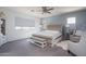 This main bedroom features a large bed, soft neutral colors and a plush seating area at 18811 W San Miguel Ave, Litchfield Park, AZ 85340