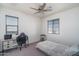 Cozy bedroom featuring a desk, chair, and ceiling fan creating a comfortable and functional living space at 18811 W San Miguel Ave, Litchfield Park, AZ 85340