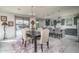 Open-concept dining area next to the kitchen, with a sliding door to the backyard at 18811 W San Miguel Ave, Litchfield Park, AZ 85340