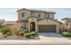 Inviting two-story home with a tile roof, a two-car garage, and low-maintenance desert landscaping at 18811 W San Miguel Ave, Litchfield Park, AZ 85340