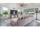 Bright living room with a large sectional sofa, tile flooring, and a ceiling fan at 18811 W San Miguel Ave, Litchfield Park, AZ 85340