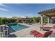 Inviting backyard with a pool, covered seating and lounge chairs, perfect for outdoor relaxation at 18811 W San Miguel Ave, Litchfield Park, AZ 85340