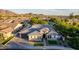 An aerial view showcases this home's appealing curb appeal, lush landscaping, and mountain views at 1925 E La Costa Dr, Gilbert, AZ 85298