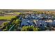 A neighborhood view showcasing homes with solar panels, pools, and green landscaping from an elevated perspective at 1925 E La Costa Dr, Gilbert, AZ 85298