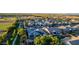 Aerial view of landscaped backyard with a pool, and houses with solar panels in a suburban neighborhood at 1925 E La Costa Dr, Gilbert, AZ 85298