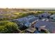 An aerial view highlights the house's roof-mounted solar panels, backyard pool, and meticulous landscaping at 1925 E La Costa Dr, Gilbert, AZ 85298