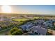 An aerial shot highlights homes with solar panels, backyards with swimming pools, and an expansive landscape at 1925 E La Costa Dr, Gilbert, AZ 85298